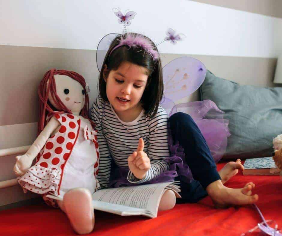 girl teaching doll