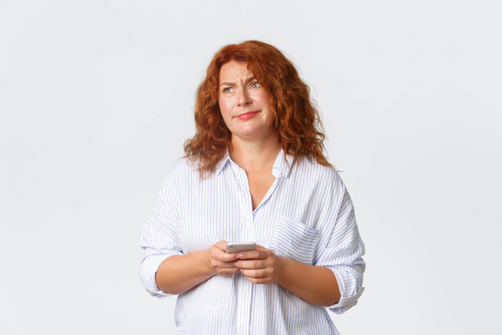 confused woman looking at website on phone