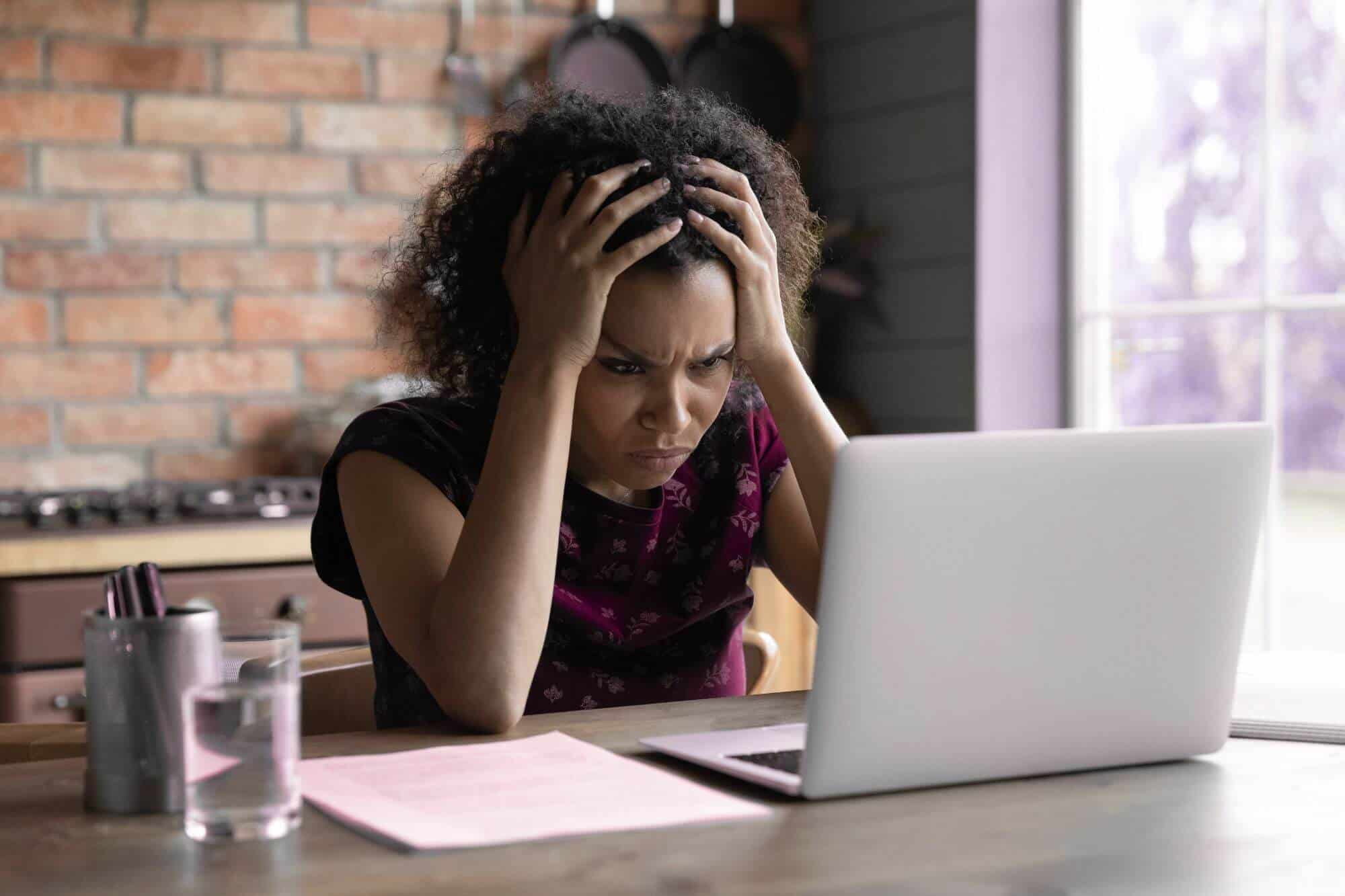 confused woman at a laptop
