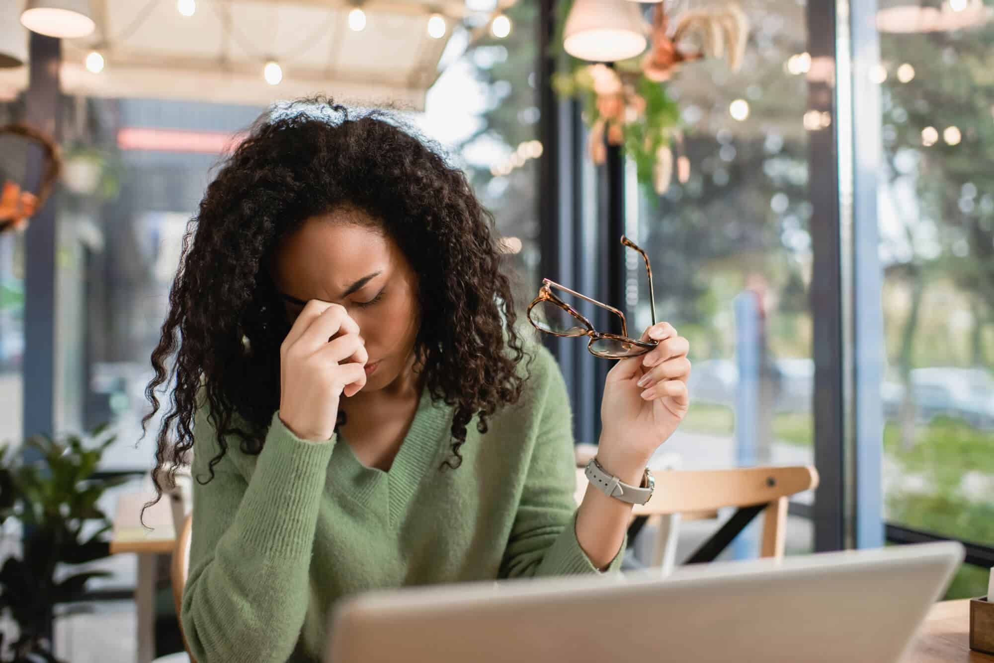 woman stressed with glasses at laptop